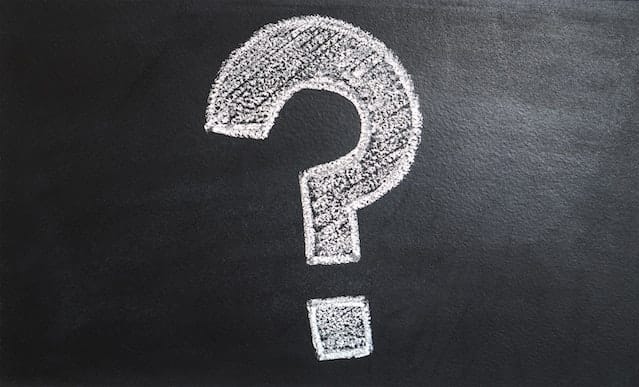 A big white question mark on a black background